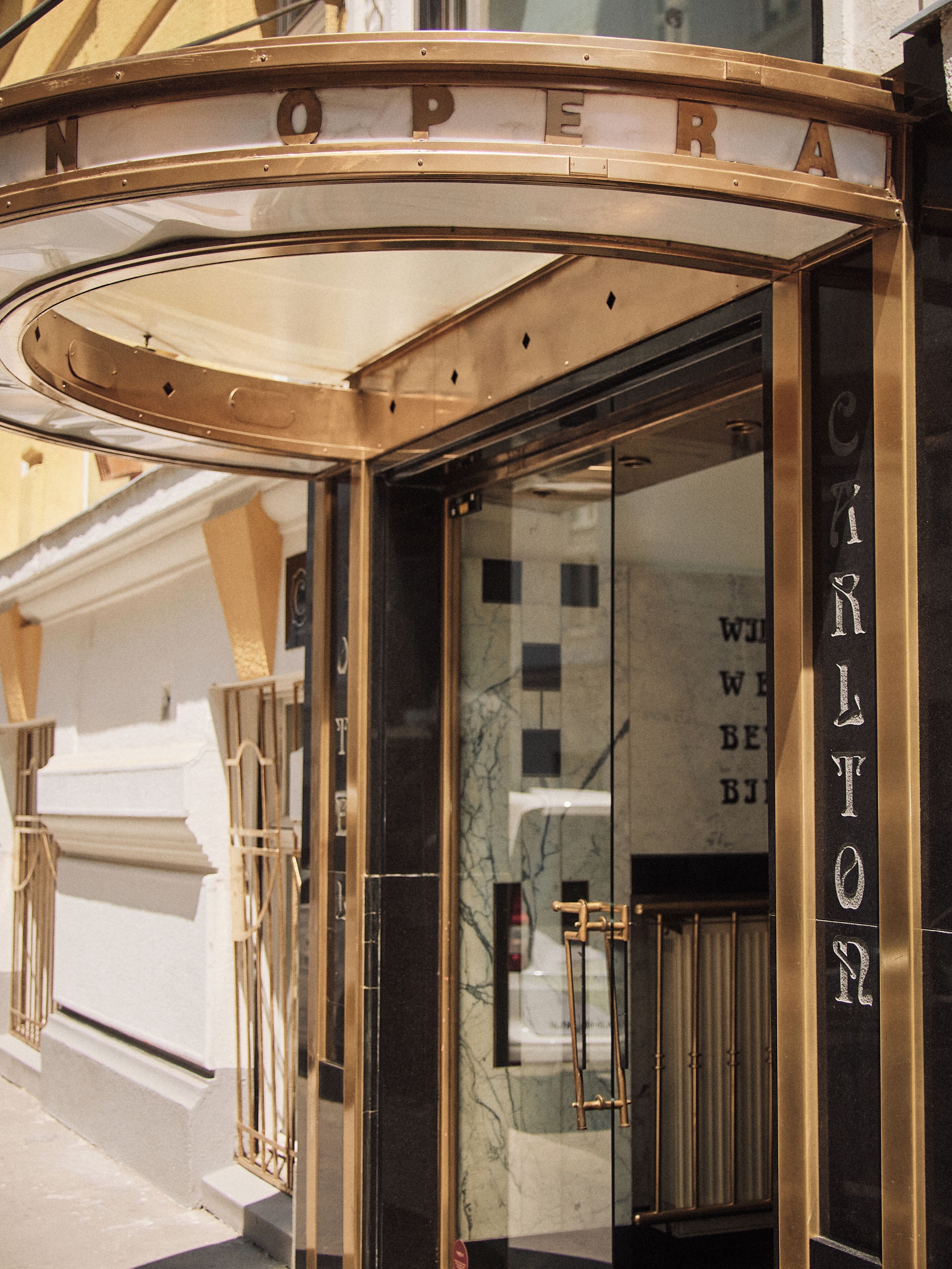 A corner entrance with a glass door, a metal frame, and the word 'CITILAND' on the glass.
