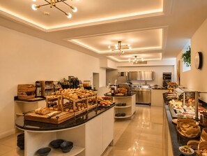 A modern kitchen with a central island, equipped with various appliances and a buffet setup. - Carlton Boutique Hotel Vienna - NEW OPENING (Vienna)