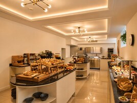 Una cucina moderna con isola centrale, dotata di diversi elettrodomestici e un'impostazione tipo buffet.