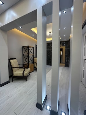 A spacious lobby with high ceilings, recessed lighting, and a modern design.