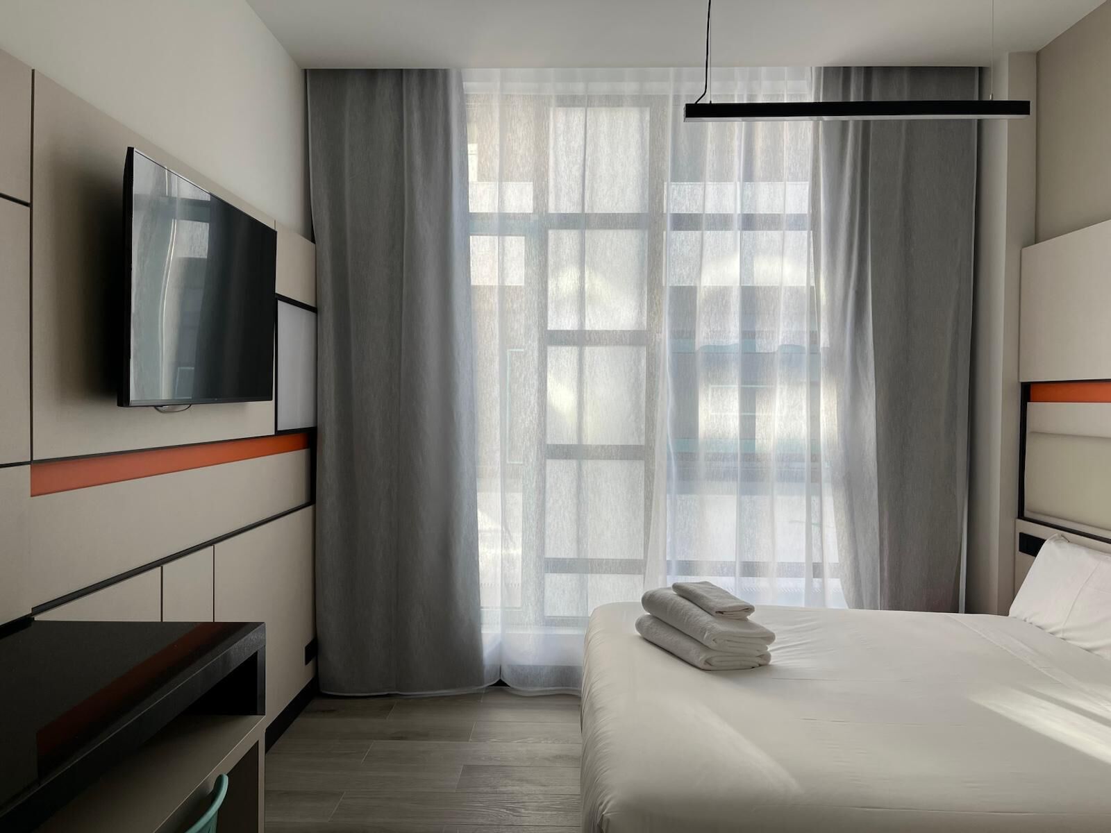 Luxe beddengoed, donzen dekbedden, een bureau, verduisterende gordijnen