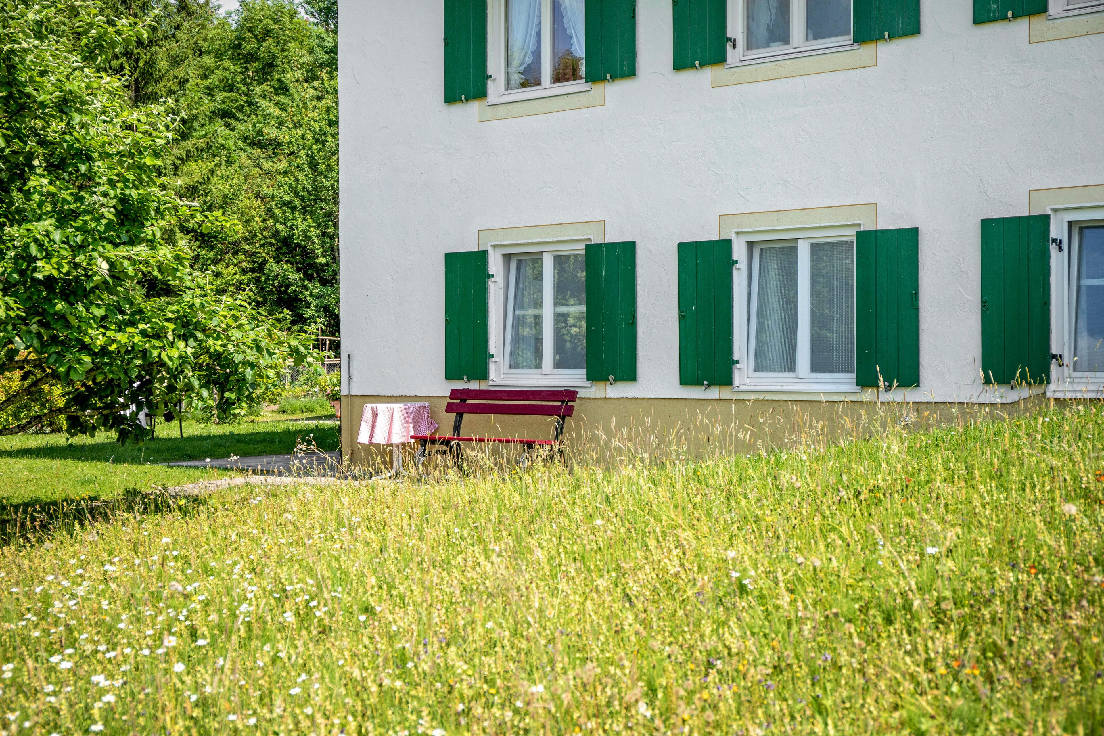 A building with multiple windows and a bench in front.