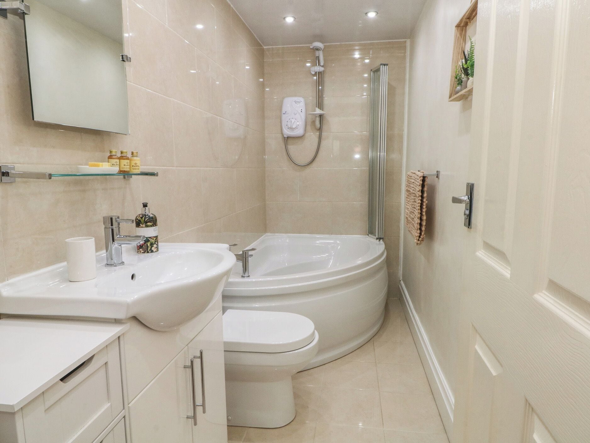A modern bathroom with a sink, toilet, and shower.