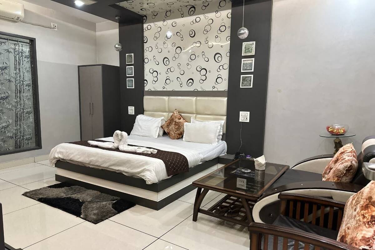 A modern bedroom with a bed, bedside table, and a glass coffee table.