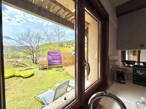 A kitchen with a view of a grassy area and a sign in French.