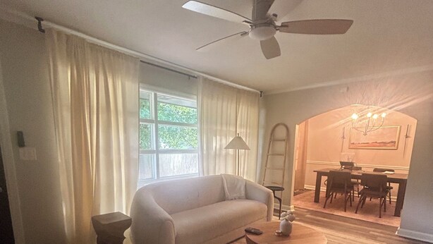 A living room with a sofa, a coffee table, a ceiling fan, and a dining area with a table and chairs. - Peaceful Atlanta Stay.
Walk to Lake & Trail. Cozy & Quiet (Tucker)