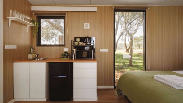 A compact kitchenette with a sink, a coffee maker, and a microwave. - Tallarook Hilltop Tiny House 4 by Tiny Away (Tallarook)