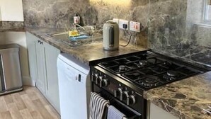 A kitchen with a stove, oven, dishwasher, and marble countertop. - No 2 Stable Yard, Wemyss Castle Estate (Kirkcaldy)