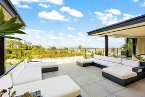 A modern outdoor seating area with a view of a city skyline. - Saint Ives Reserve - Sunset Strip Retreat w/ Epic City-to-Ocean Views (Los Angeles)