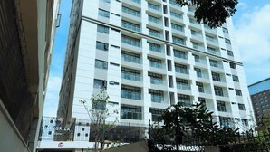 A multi-story building with a modern architectural design, featuring a series of balconies and large windows. - Breeze By Edmor Suites (Nairobi)