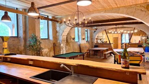 A rustic interior with a pool table, wooden bar, and arched ceiling. - Domaine de la Francoise (Dieulefit)