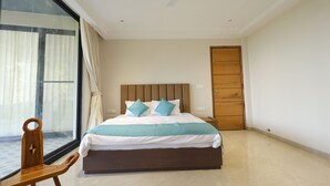 A bedroom with a bed, a wooden headboard, a ceiling fan, a window with curtains, and a wooden door. - MINARA MEADOWS (Kasauli)