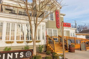 A building with a sign reading 'PARLOUR A PINTS' and a staircase leading to the entrance. - Modern Jeffersonville retreat w/ private backyard! (Jeffersonville)