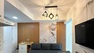 Family Condo, Balcony, City View | Living area | 110-cm Smart TV with digital channels