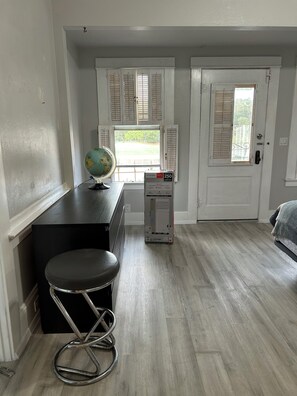 A room with a desk, a globe, a radiator, and a door with a window. - 3-bedroom house in fabulous Crockett with cool AC (Crockett)