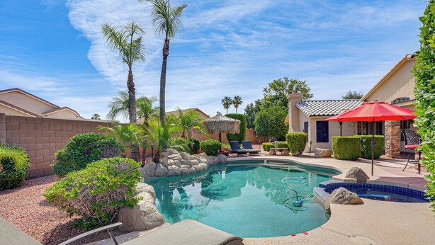 A swimming pool with lounge chairs, palm trees, and a red umbrella. - Game Room, Backyard Oasis! Glendale Group Getaway (Glendale)