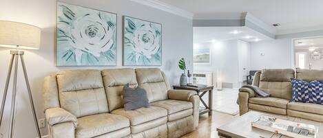 A living room with two sofas, a coffee table, and a lamp.