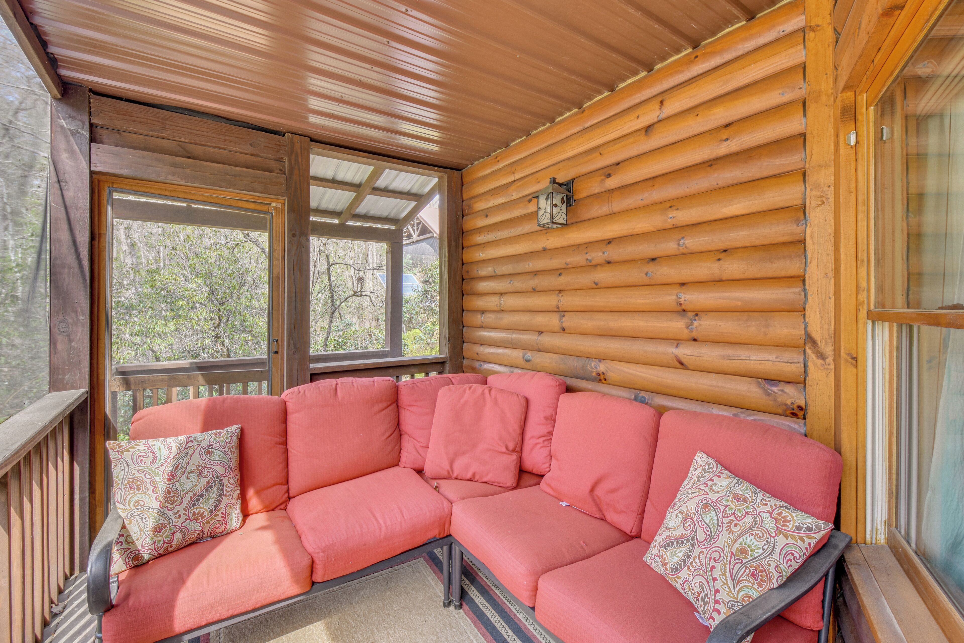 A wooden cabin with a curved sofa and a window.