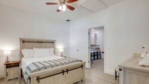 A bedroom with a bed, bedside tables, a ceiling fan, and a view into another room. - 2 Mi to Historic Dtwn St Augustine! Family Retreat (St. Augustine)