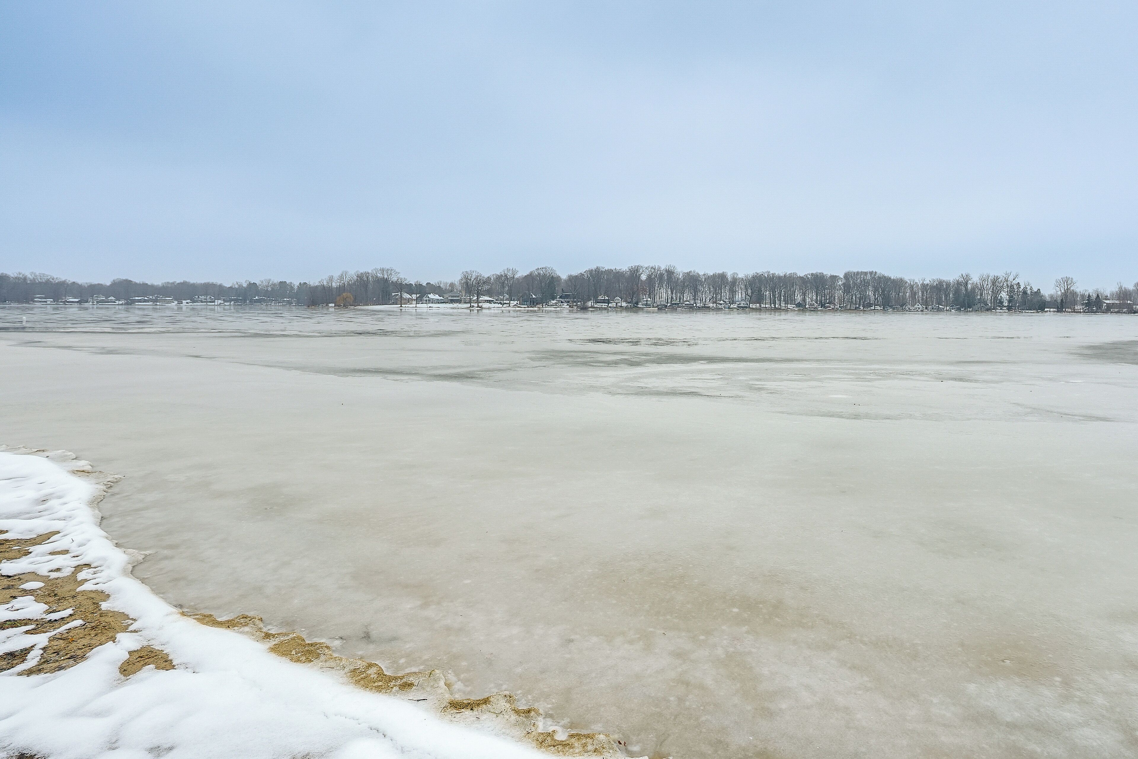 A frozen lake with a clear sky.