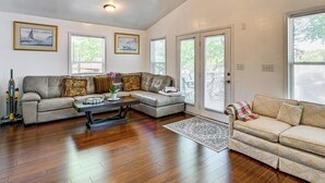 A spacious living room with a large sofa, a smaller sofa, a coffee table, and a ceiling fan. - Private Dock! High Rock Lake Getaway in Lexington (Lexington)