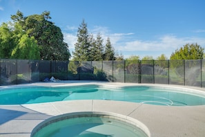 A swimming pool with a clear view of the surrounding trees and a fenced area. - Poolside Escape w/ Hot Tub! 8 Mi to Dtwn Modesto (Ripon)