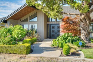 A modern building with a large entrance, a covered porch, and well-maintained landscaping. - Poolside Escape w/ Hot Tub! 8 Mi to Dtwn Modesto (Ripon)