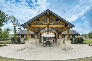 A covered pavilion with a picnic table, stone pillars, and a gated entrance. - Pool & Dog Park Access! Porter Family Home w/ Yard (Porter)