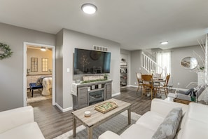 A living room with a fireplace, a dining area, and a staircase. - Missouri Wine Country Retreat w/ Hot Tub & BBQ (Imperial)