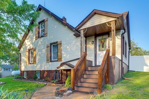 A two-story house with a front porch, a wooden staircase, and a small front yard. - Missouri Wine Country Retreat w/ Hot Tub & BBQ (Imperial)