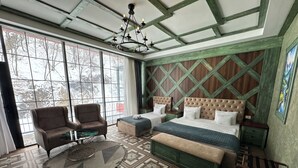 A bedroom with two beds, a large window, a chandelier, and a patterned floor. - Tengealti Resort Hotel (Quba)