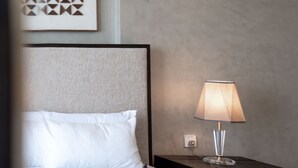 A hotel room with a bed, a nightstand with a lamp, and a wall-mounted power outlet. - Free Housekeeping Visits During Your Stay - Stayshort - Stunning 1 Bed in Maritime City That Sleeps 2 (Dubai)