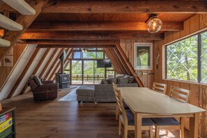 A wooden interior with a dining table, sofas, and a fireplace. - Camp Bergisel by Innsbrook Vacations! (Wright City)