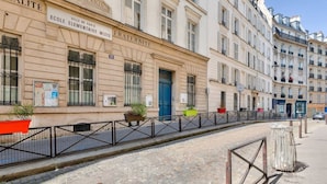 A street with historic buildings, including a building labeled 'Ecole Elementaire Mixte.'