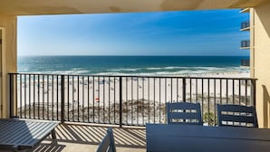 A balcony with a view of a beach and ocean. - Phoenix V 801 3 Bedroom Condo (Orange Beach)