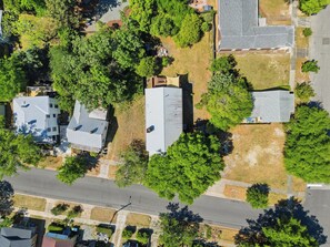 An aerial view of a residential area with houses, trees, and a road. - Snipes-Taylor House: Historic Charm &Walk to DT! Huge porch and backyard! (Wilmington)