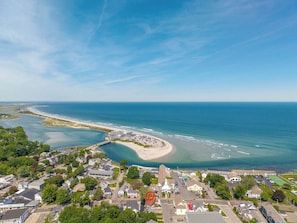 An aerial view of a coastal town with a beach, residential areas, and a prominent church. - Casa sul Mare Near the Coast (Ogunquit)