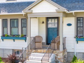 A two-story house with a front porch, stone steps, and a blue door. - Casa sul Mare Near the Coast (Ogunquit)