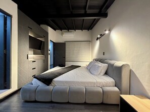 A modern bedroom with a built-in bed, a wardrobe, a ceiling light, and a window.