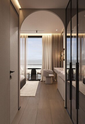 A modern hotel room with a balcony, a sofa, a small table, and a view of the sea. - Latyrian Hotel (Durrës)