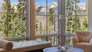A room with a large window, a cushioned bench, a round table, and a chair. - Ski In/Out, Hot tub, Sauna, Fireplaces, Fire Pit, Game Room (Mountain Village)
