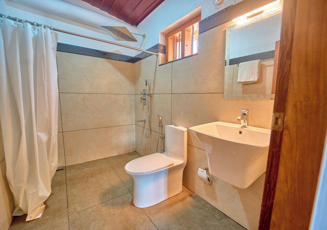 Un bagno con il water, doccia e lavandino.