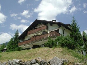 A multi-story building with balconies, surrounded by greenery and mountains. - Chesa Rievanot, (Bergün/Bravuogn), 136 by Interhome (Bergün)