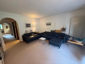 A living room with a sectional sofa, a coffee table, and two wall-mounted lamps. - Chesa Rievanot, (Bergün/Bravuogn), 136 by Interhome (Bergün)