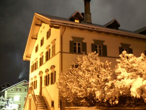 A multi-story building with a snow-covered tree in the foreground. - Haus Buol Bergün, (Bergün/Bravuogn), 213 by Interhome (Bergün)