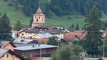A town with a prominent church tower, surrounded by residential buildings and greenery.