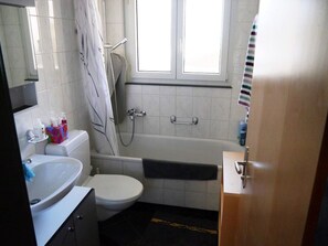 A bathroom with a toilet, sink, bathtub, and shower. - Casa Crispalt Monn, (Sedrun), 187.03 by Interhome (Sedrun)