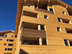 A multi-story building with balconies and windows.