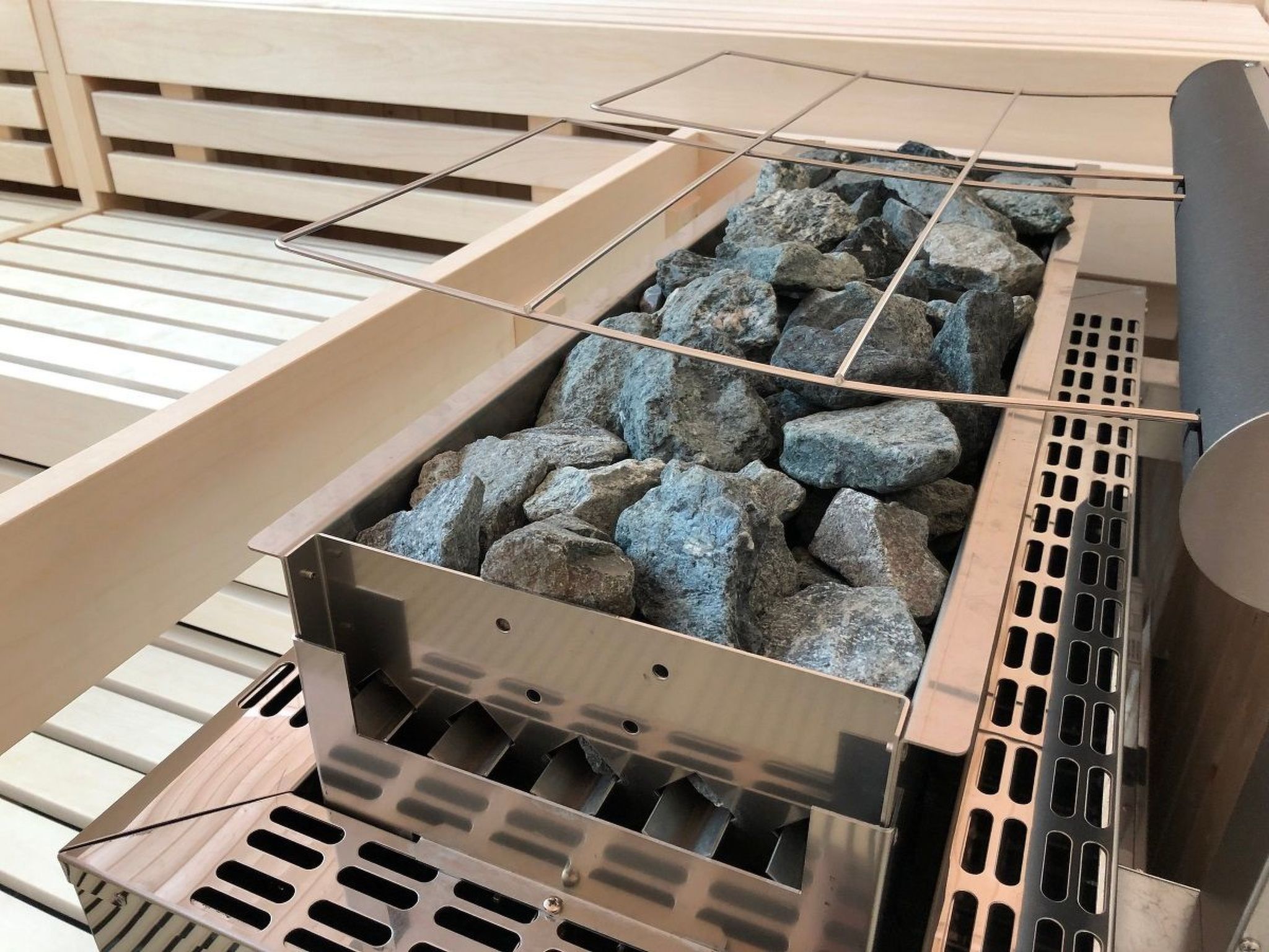 A grill with rocks and metal grates.