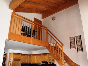 A wooden staircase leading to a lofted area with a view of the kitchen below. - Casa Mulinera 2 Derycke, (Camischolas/Sedrun), 243.02 by Interhome (Camischolas)